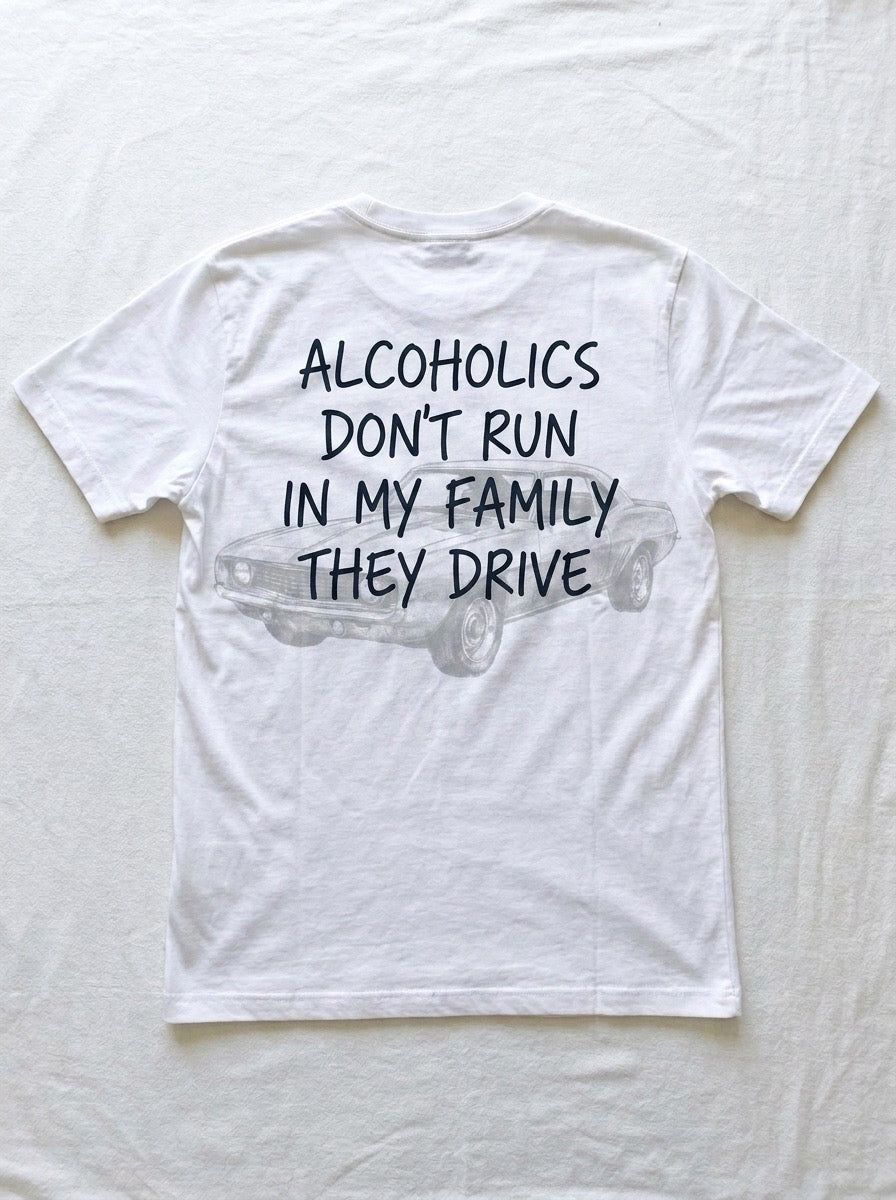 Back of a white t-shirt printed with alcoholics don't run in my family they drive over a faint line drawing of a parked muscle car.