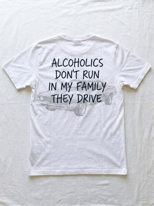 Back of a white t-shirt printed with alcoholics don't run in my family they drive over a faint line drawing of a parked muscle car.
