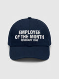 Navy dad hat embroidered in white with EMPLOYEE OF THE MONTH above FEBRUARY 1999.