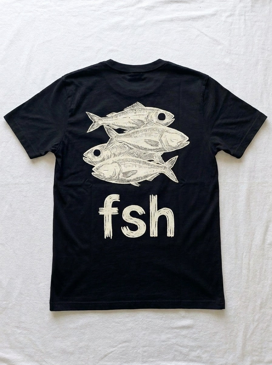 Back of a black t-shirt printed with a white ink drawing of three fish above the lowercase letters f s h.
