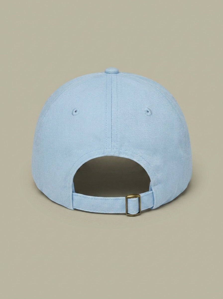 Back of the pale blue junior curling hat, showing the adjustable strap.