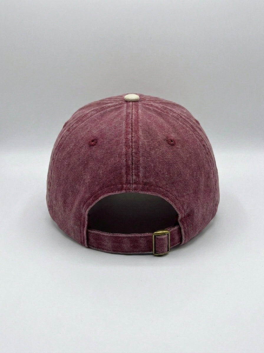 Back of the maroon and cream probably hat, showing the adjustable strap.
