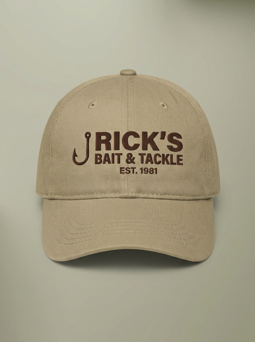 Khaki dad hat embroidered in dark brown with a fish hook beside RICK'S BAIT & TACKLE and EST. 1981.