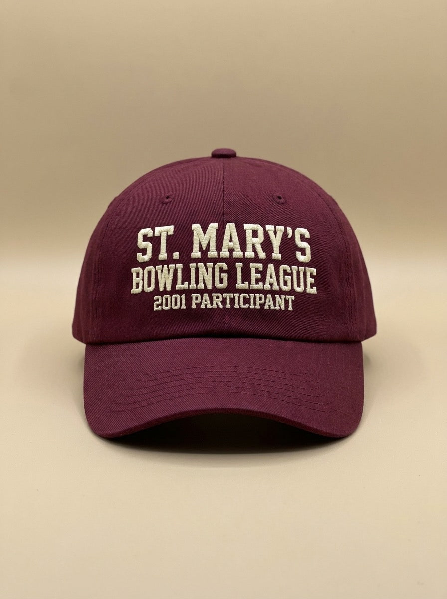 Maroon dad hat embroidered in cream with ST. MARY'S BOWLING LEAGUE and 2001 PARTICIPANT.