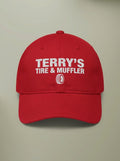 Red dad hat embroidered in white with TERRY'S TIRE & MUFFLER above a tire outline.
