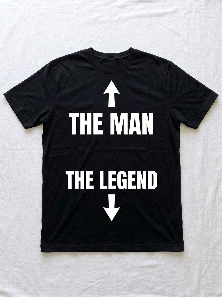 Back of a black t-shirt printed with an arrow up above THE MAN, and THE LEGEND above an arrow down.