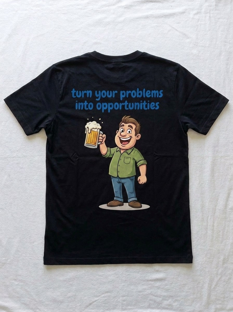 Back of a black t-shirt printed with turn your problems into opportunities above a cartoon man raising a mug of beer.